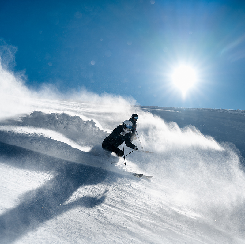 Eine Person fährt mit Skiern einen Hang hinunter.